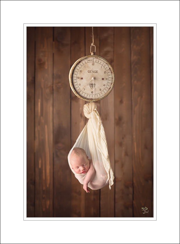 Seattle Newborn Photographer_Jennifer Wilcox Photography_Baby hanging from scale (1)
