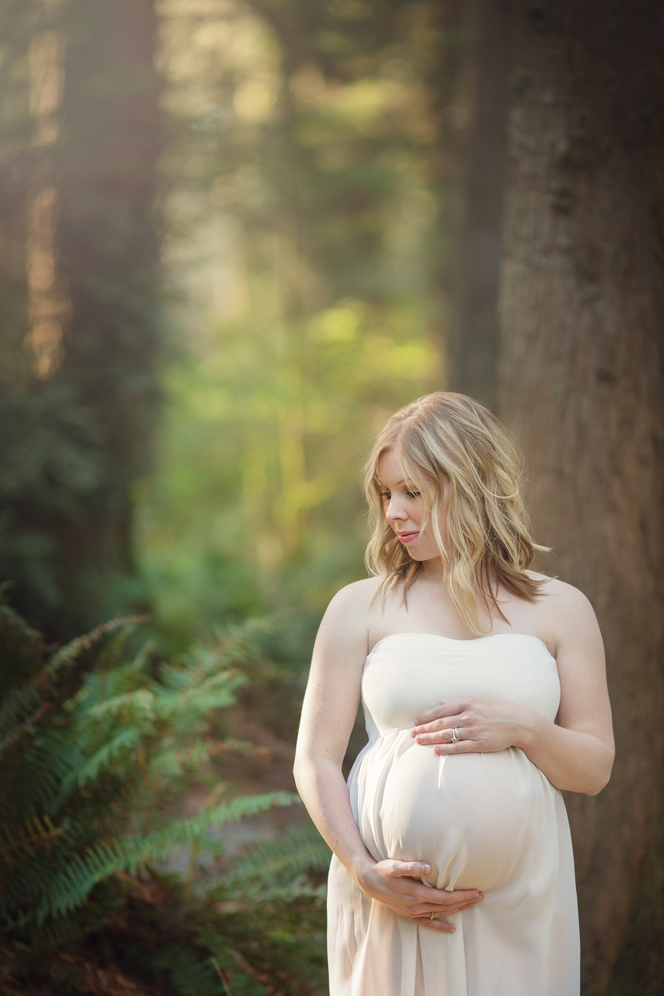 Maternity portrait of pregnant woman in beautiful Washington forest.